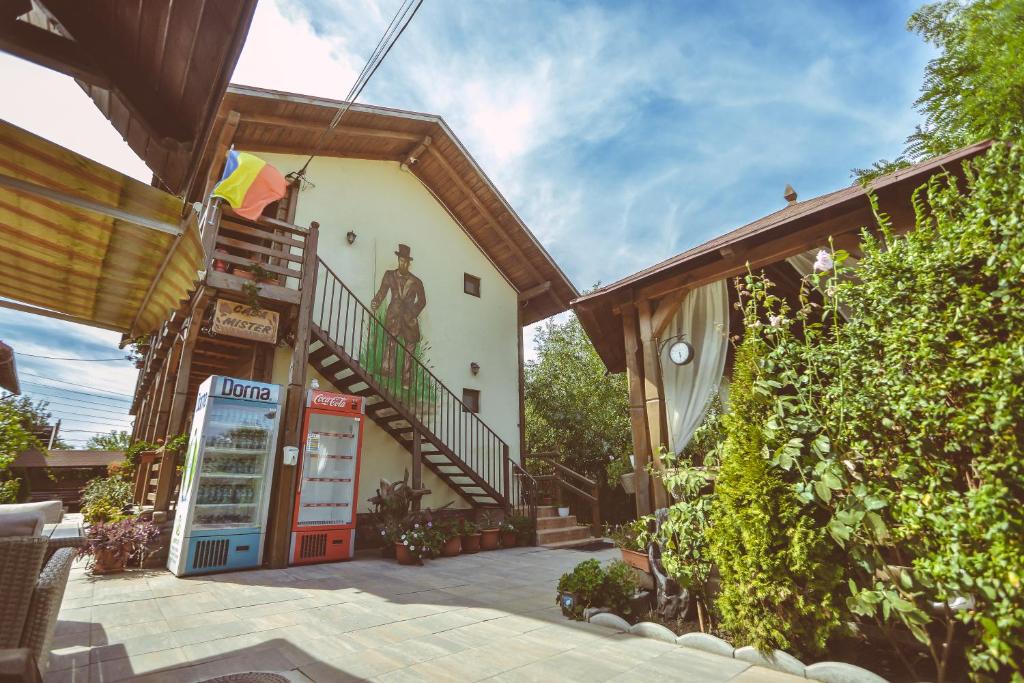 a house with a soda machine next to a building at Casa Mister in Sulina