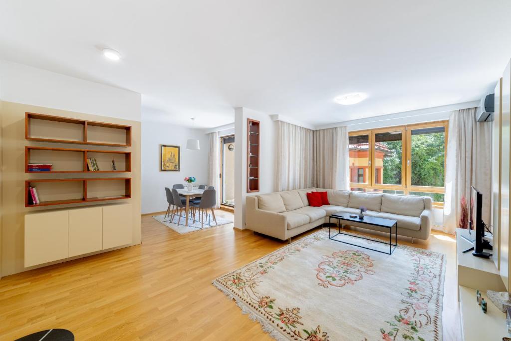 a living room with a couch and a table at Skenderpasina Skyline 2-bedroom apartment with balcony in Sarajevo