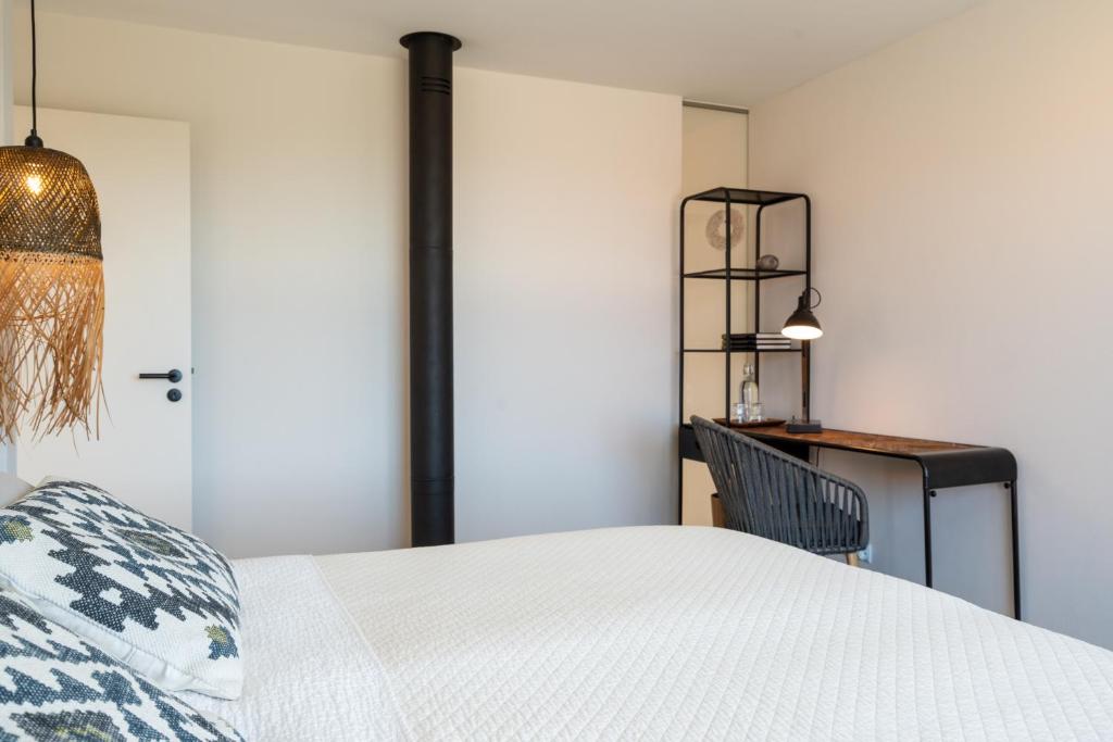 Postel nebo postele na pokoji v ubytování Casa da Adraga