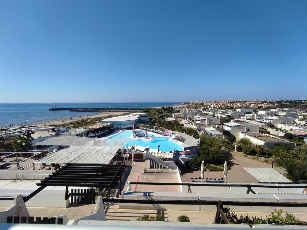 un complexe avec piscine et plage dans l'établissement Duplex 121A, Port nature, au Cap d'Agde