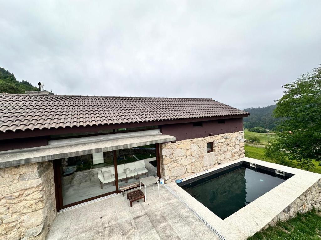 a house with a swimming pool in front of it at Chalet con piscina Gondomar in Gondomar