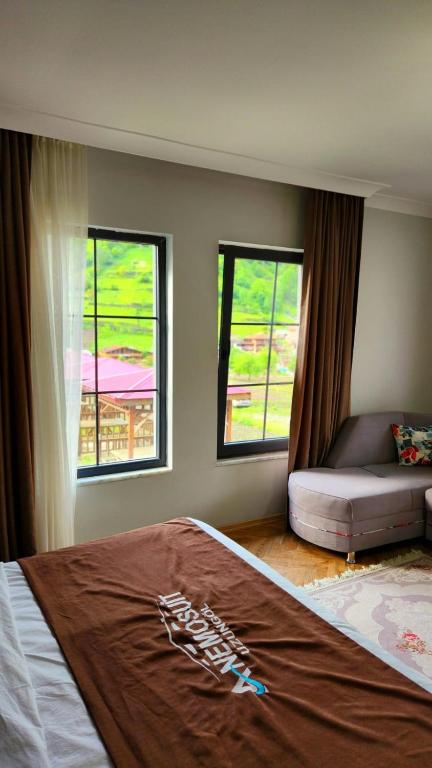 A bed or beds in a room at Anemo Suite
