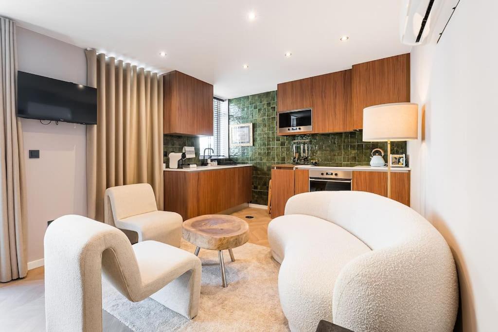 a living room with a couch and chairs and a kitchen at Beachside House in Matosinhos by Lisbeyond in Matosinhos