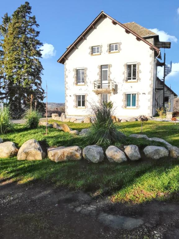 a house with rocks in front of it at Maison de 7 chambres avec jardin clos et wifi a Montsalvy in Montsalvy