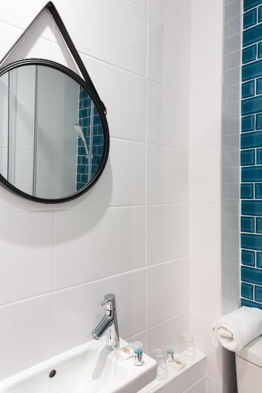 a bathroom with a sink and a mirror on the wall at Hotel Nap By HappyCulture in Nice