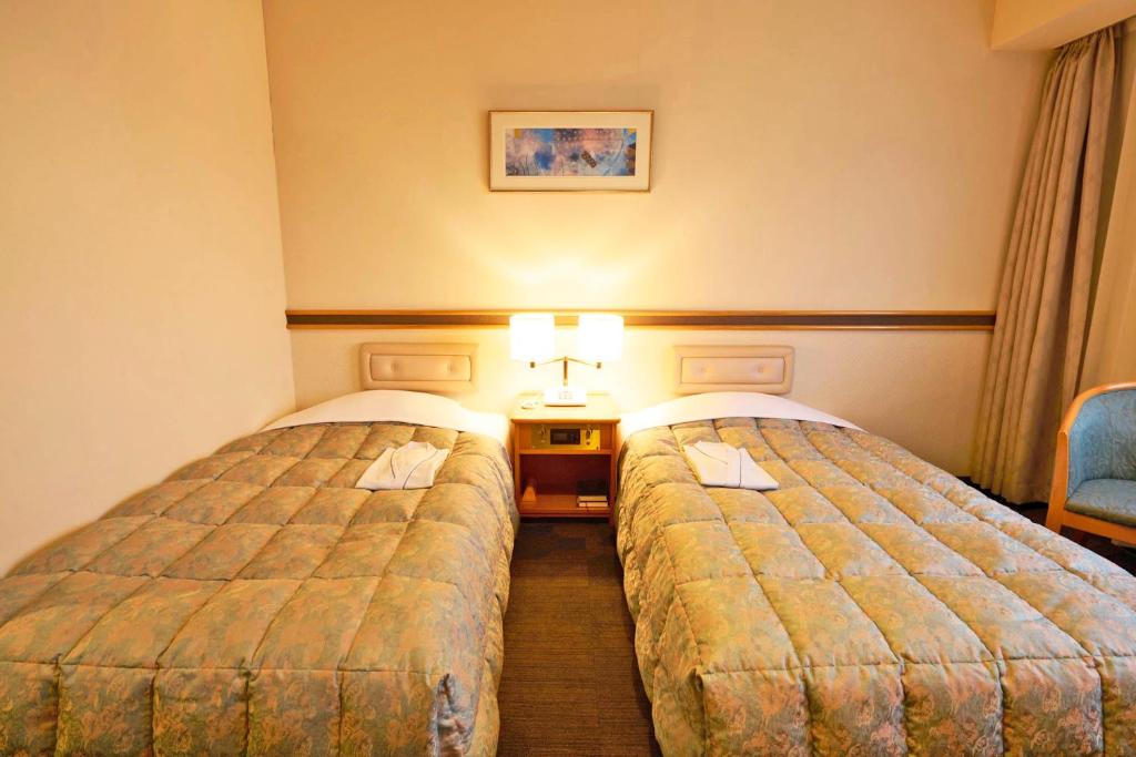 Postel nebo postele na pokoji v ubytování Ageo Tobu Hotel