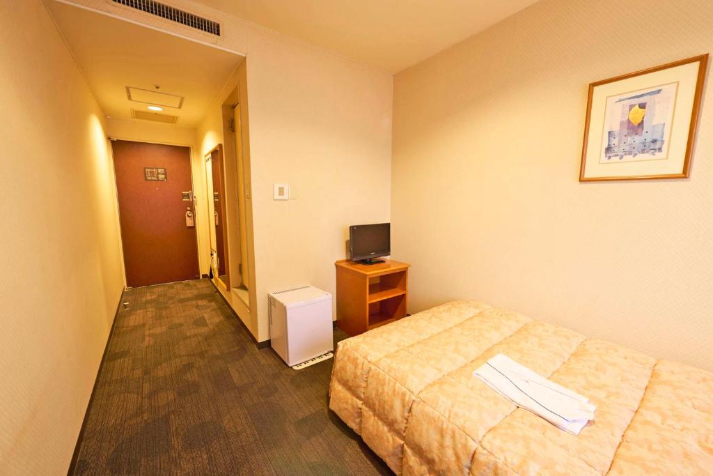 Postel nebo postele na pokoji v ubytování Ageo Tobu Hotel