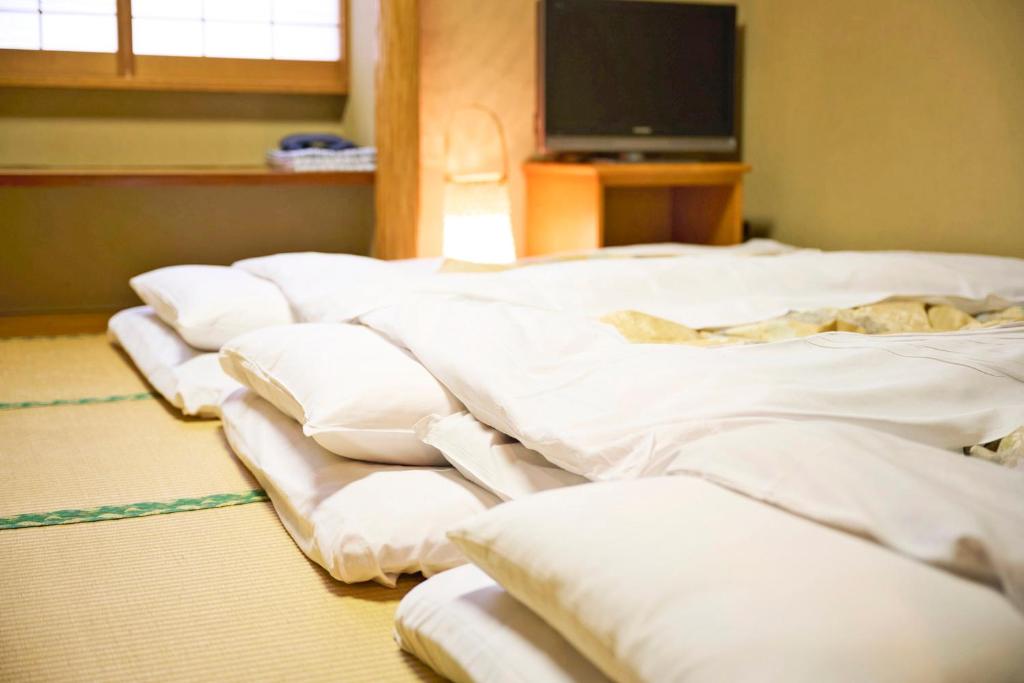 Postel nebo postele na pokoji v ubytování Ageo Tobu Hotel