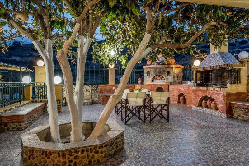 a building with a house with a tree in a courtyard at Katerina's garden Apartment 1 - Tertsa Ierapetra in Térsa