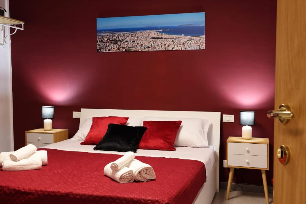 a bedroom with two beds with red and white at A casa di Stefy in Trapani