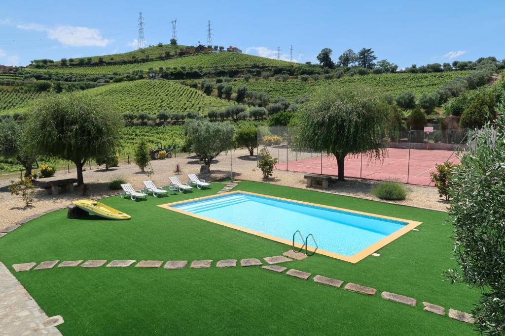 an image of a swimming pool in a yard at Casa Da Formiga in Juncal de Cima