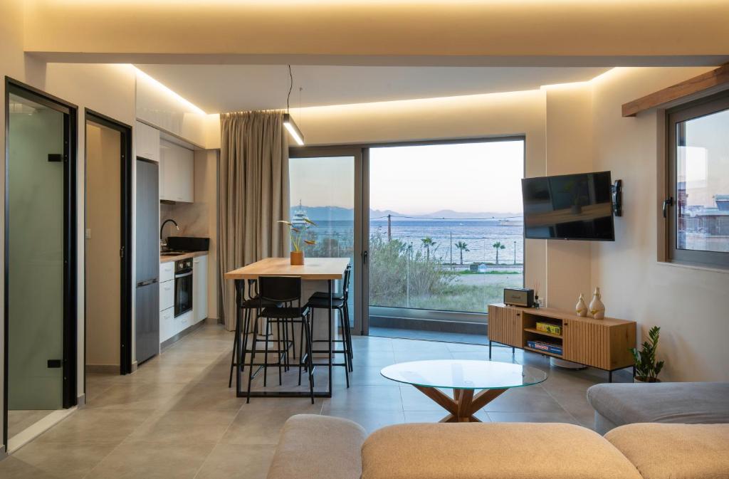 a living room with a couch and a table and a kitchen at 400 Steps Apartment with Sea View near Old Town in Rhodes Town