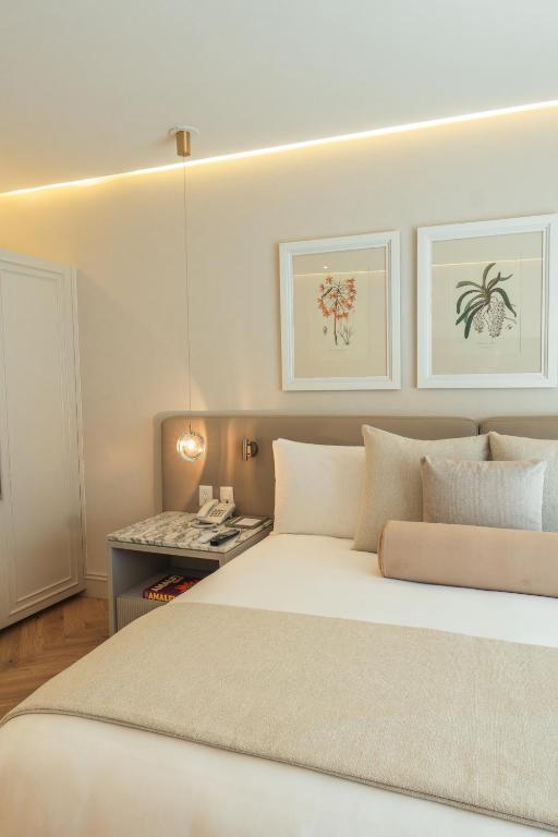 Postel nebo postele na pokoji v ubytování Hotel Maria Camille