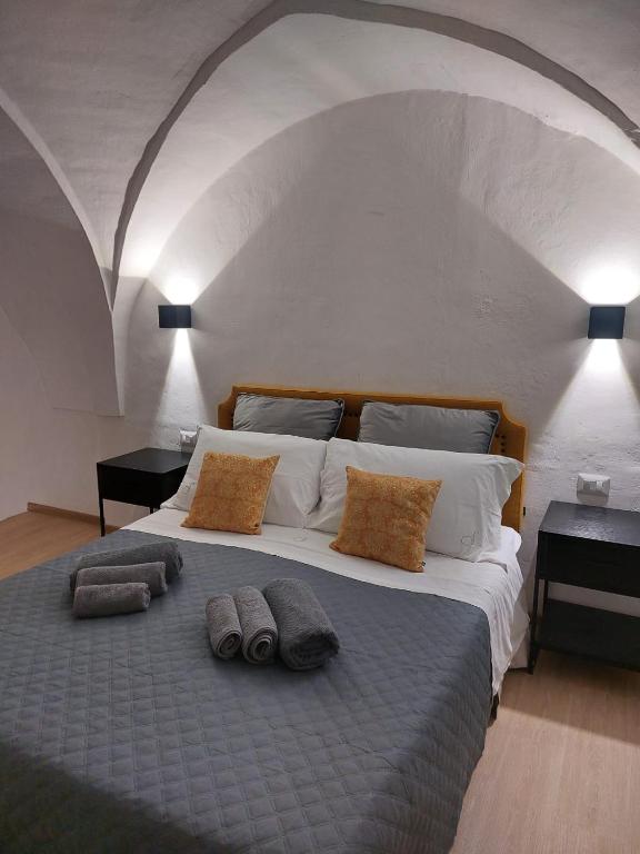 a large bed with two pillows on top of it at Dimora Apulia 5 in Gallipoli