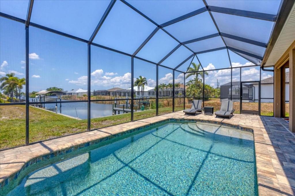 a swimming pool in a house with a glass ceiling at 10333 Monticello Dr in Port Charlotte