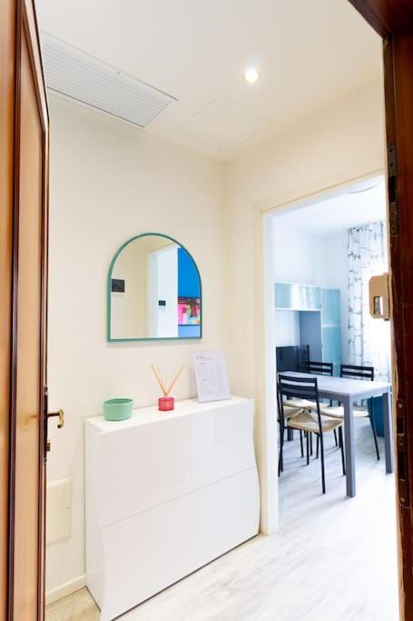a dining room with a table and a mirror at Modern Studio della Valle x2 in Padova
