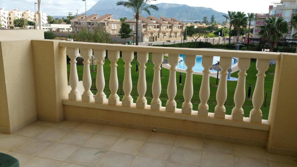 a balcony with a white railing with a view of a city at Playa Sol Mediterranea in Denia