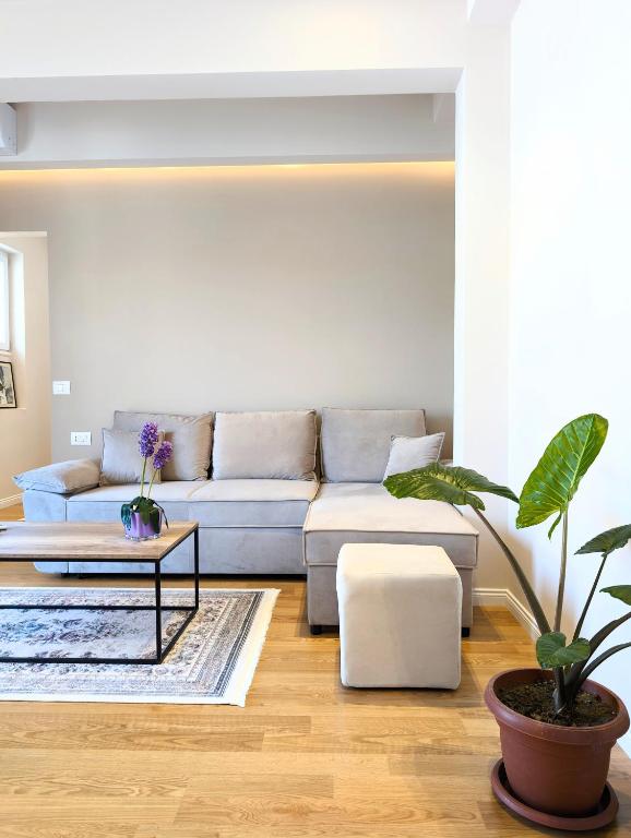 a living room with a couch and a table at Villa with Garden & Balcony in Berat