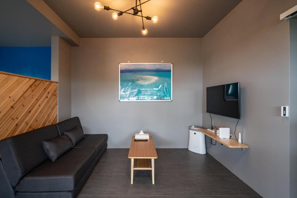 a living room with a couch and a tv at Coteji Do - Vacation STAY 92057v in Ishigaki Island