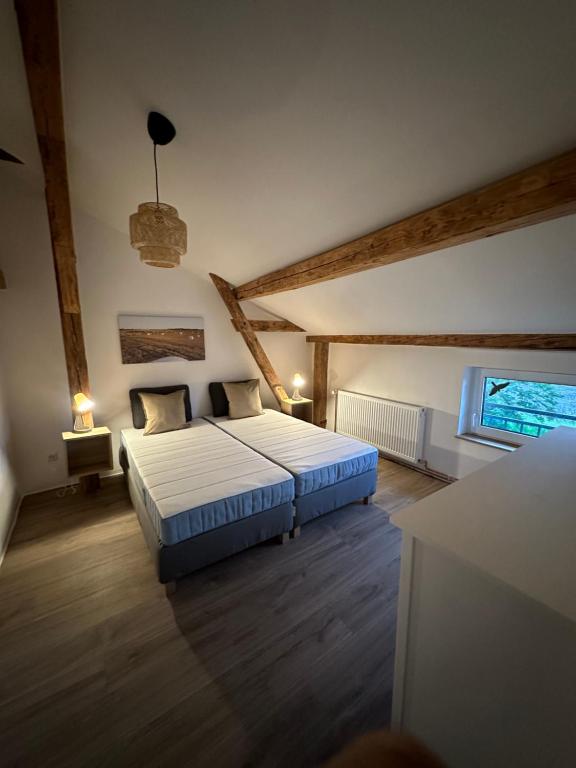 a bedroom with a large bed in a attic at Zum Singschwan in Rieseby