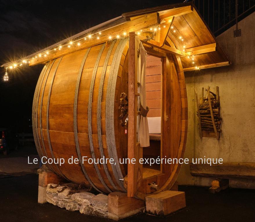 a large wooden wine barrel with lights on it at Chalet Diognysos B&B, Boutique Hotel & Wellness in Crans-Montana