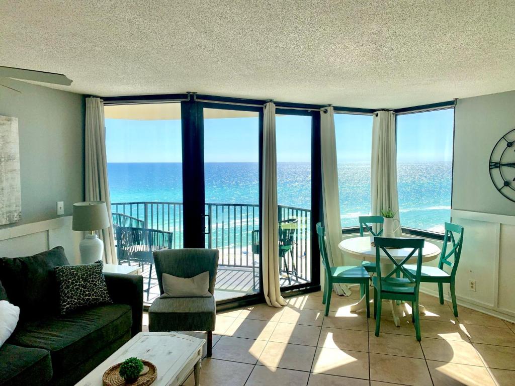 a living room with a view of the ocean at Sunbird Sunsets in Panama City Beach