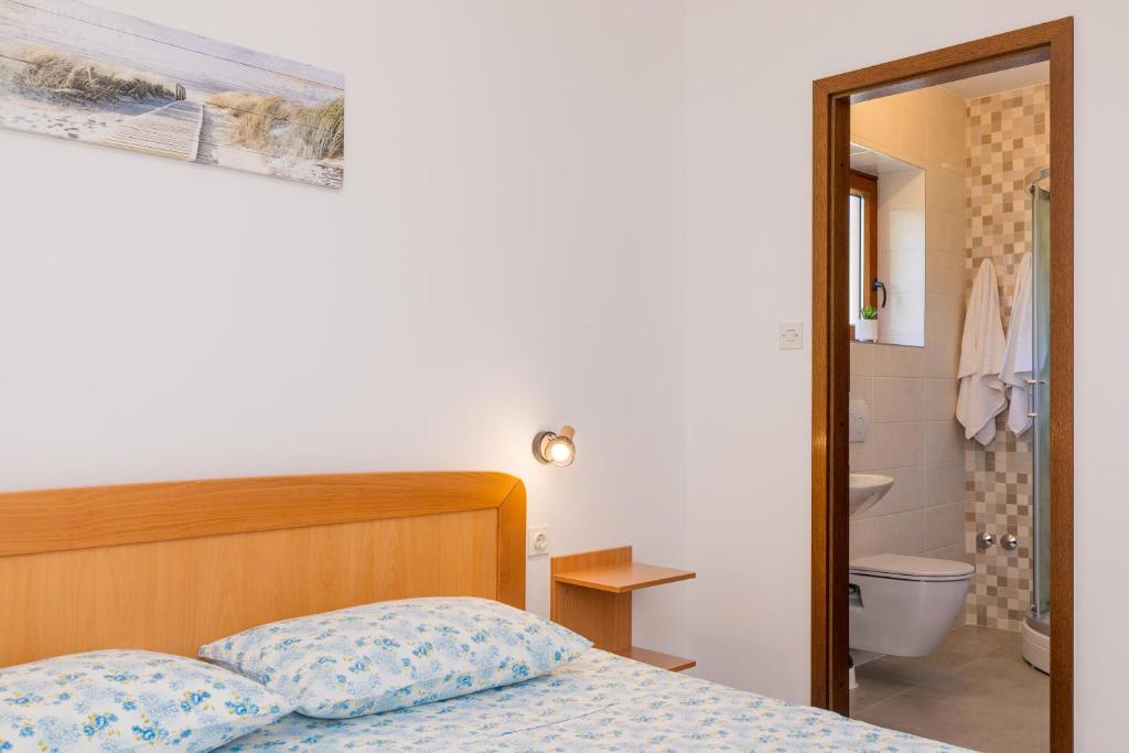 Posteľ alebo postele v izbe v ubytovaní Apartmani Pina