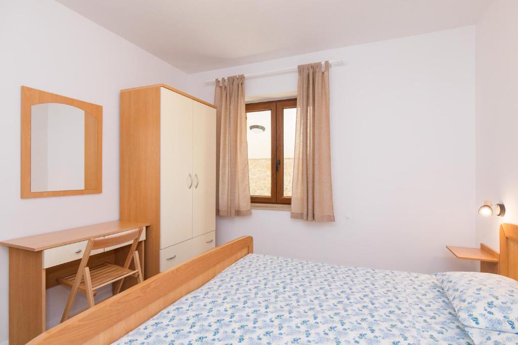 Posteľ alebo postele v izbe v ubytovaní Apartmani Pina