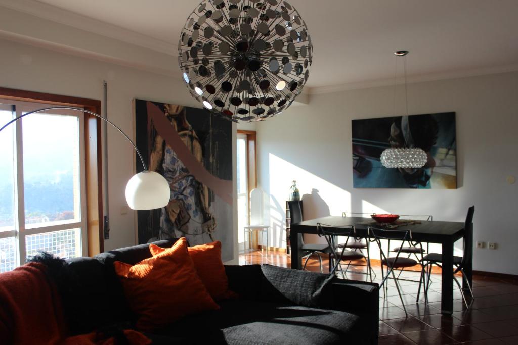a living room with a couch and a table at Apartamento Montes e Vales no Centro in Vila Real