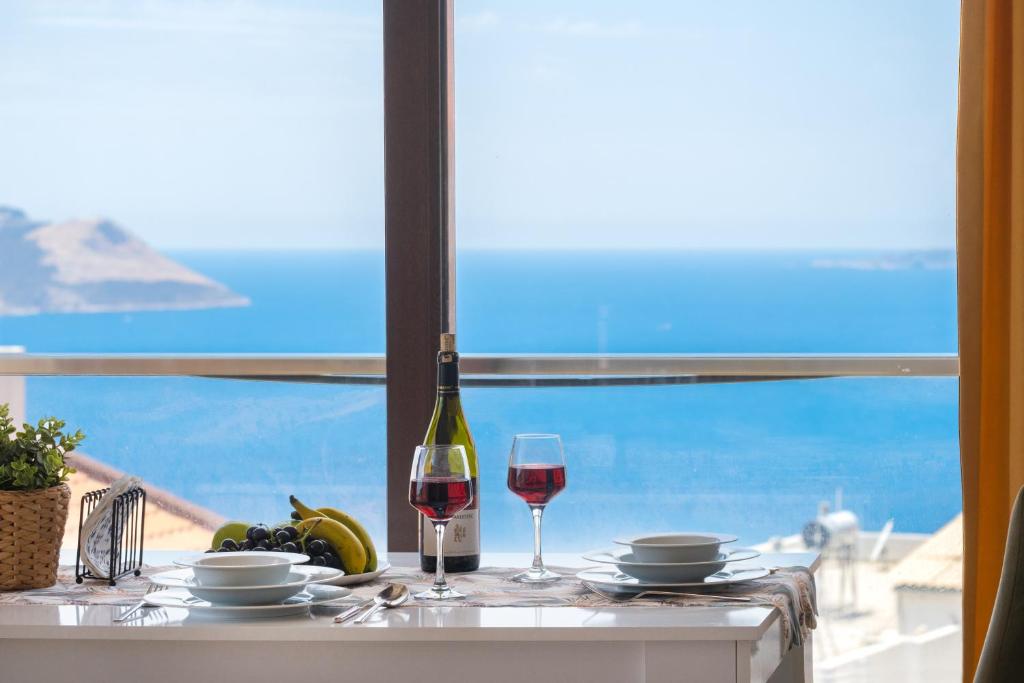 a table with a bottle of wine and a glass at Blue View Suites Kaş in Kas