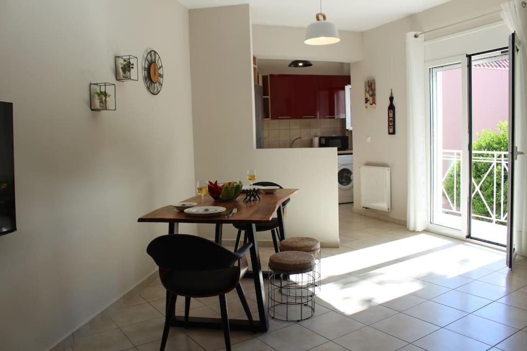 a kitchen and dining room with a table and chairs at Apartment Lucia in Argostoli