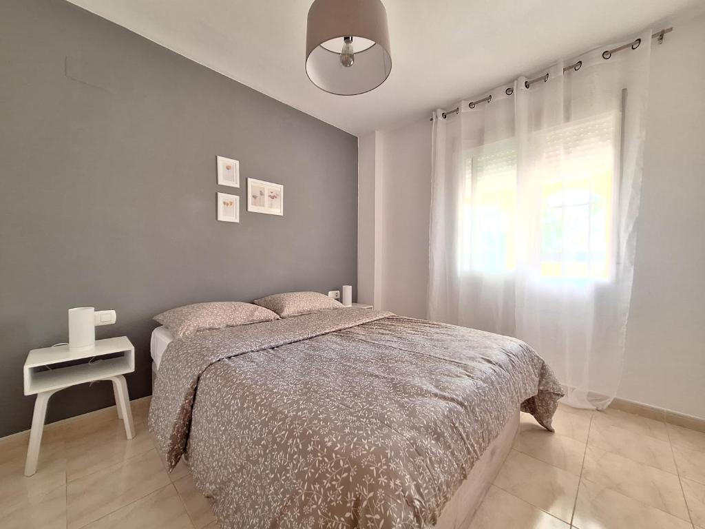 A bed or beds in a room at Playa Denia