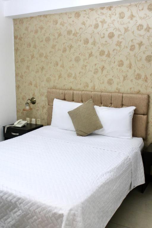 Postel nebo postele na pokoji v ubytování Hotel Presidente Internacional