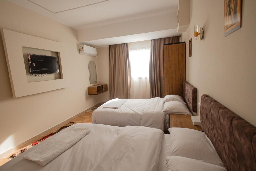 Postel nebo postele na pokoji v ubytování The View Pyramids Hotel