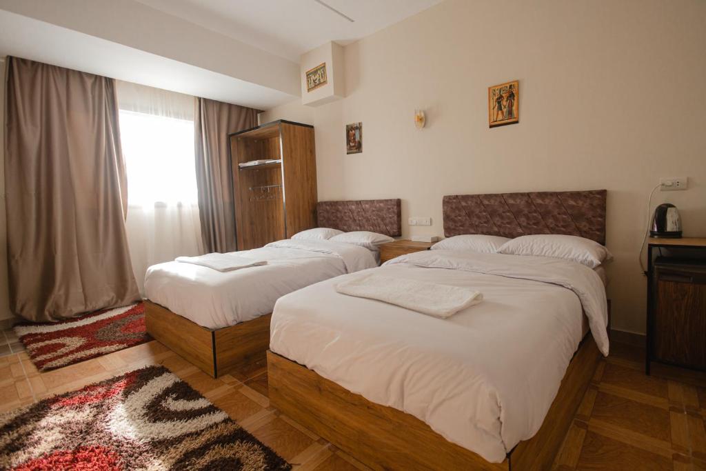 Postel nebo postele na pokoji v ubytování The View Pyramids Hotel