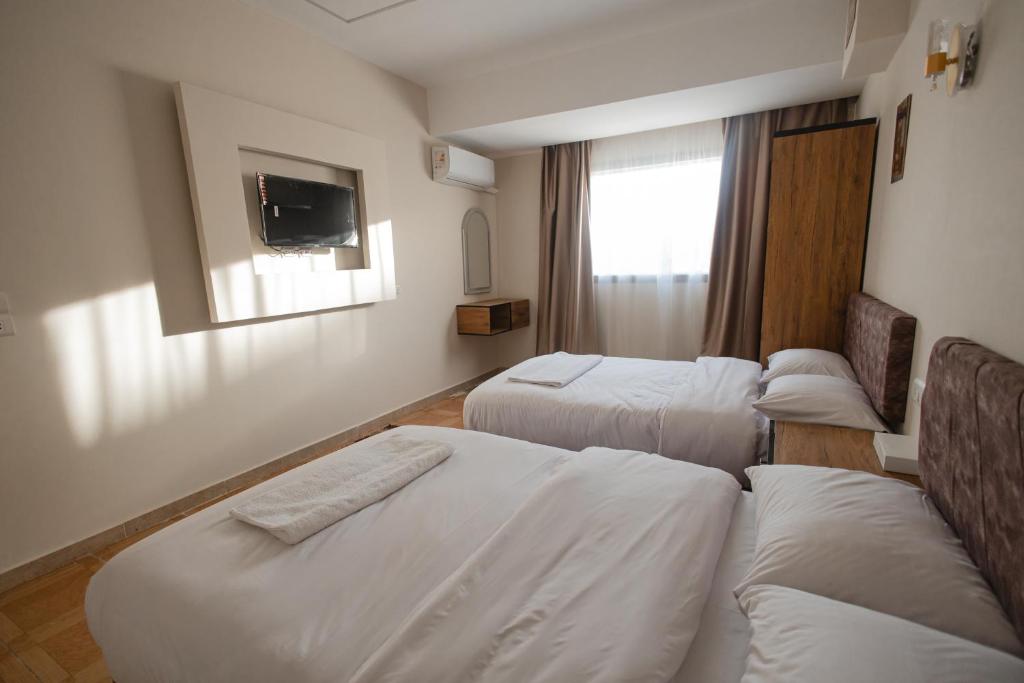 Postel nebo postele na pokoji v ubytování The View Pyramids Hotel