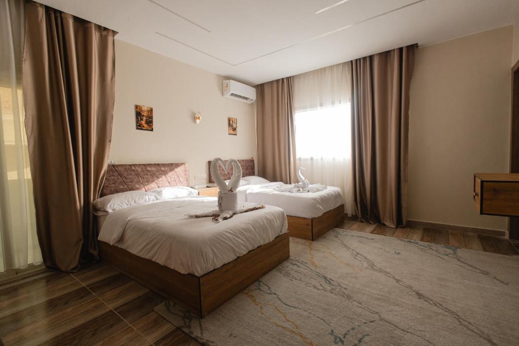 Postel nebo postele na pokoji v ubytování The View Pyramids Hotel
