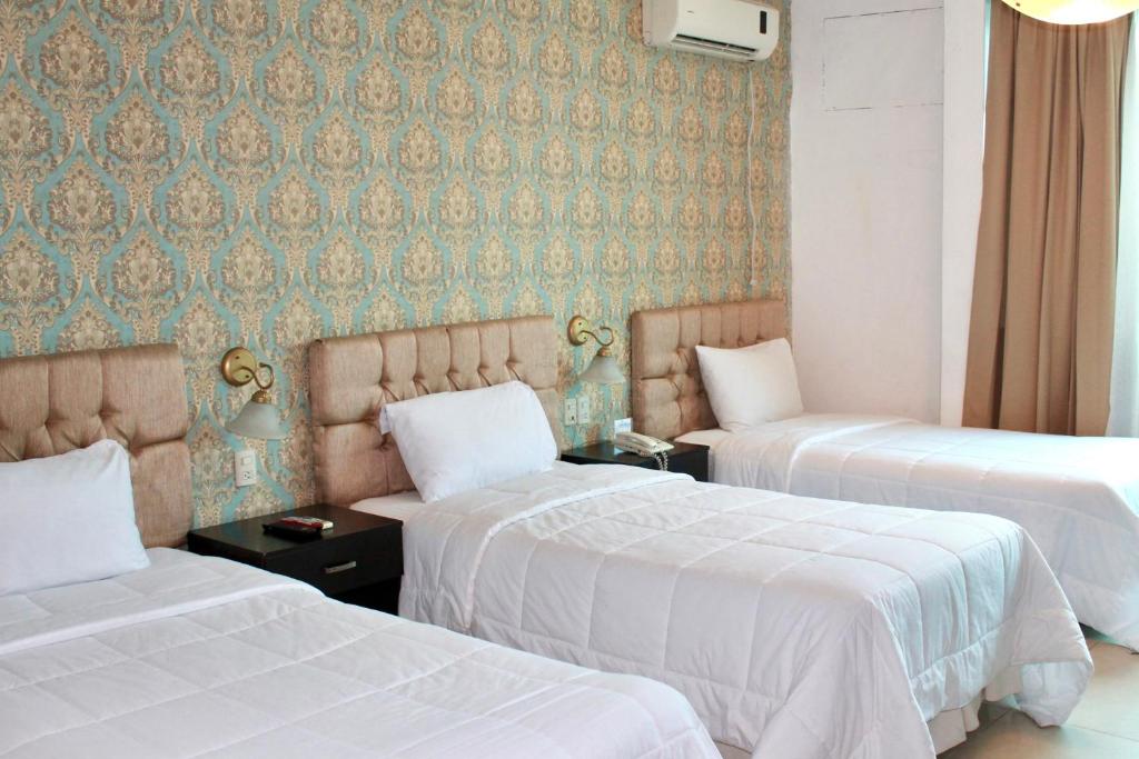 Postel nebo postele na pokoji v ubytování Hotel Presidente Internacional