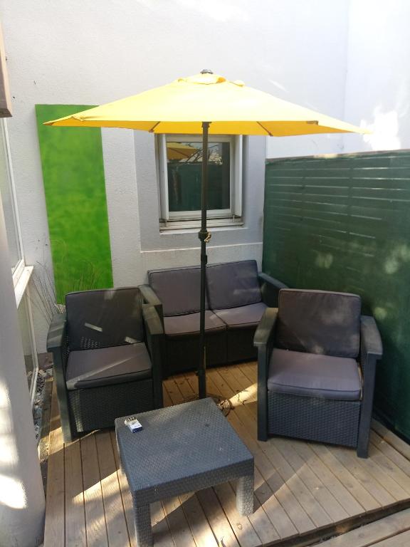a patio with chairs and an umbrella and a table at Le Loft in Montpellier