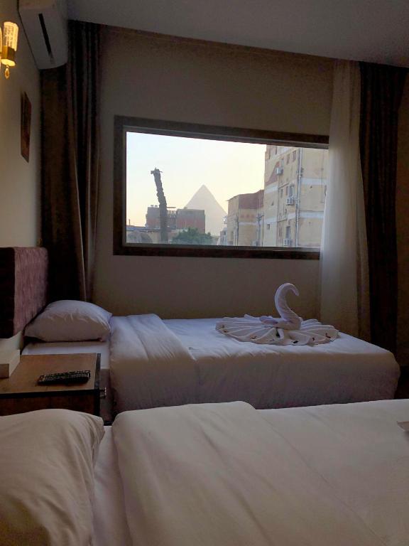 Postel nebo postele na pokoji v ubytování The View Pyramids Hotel