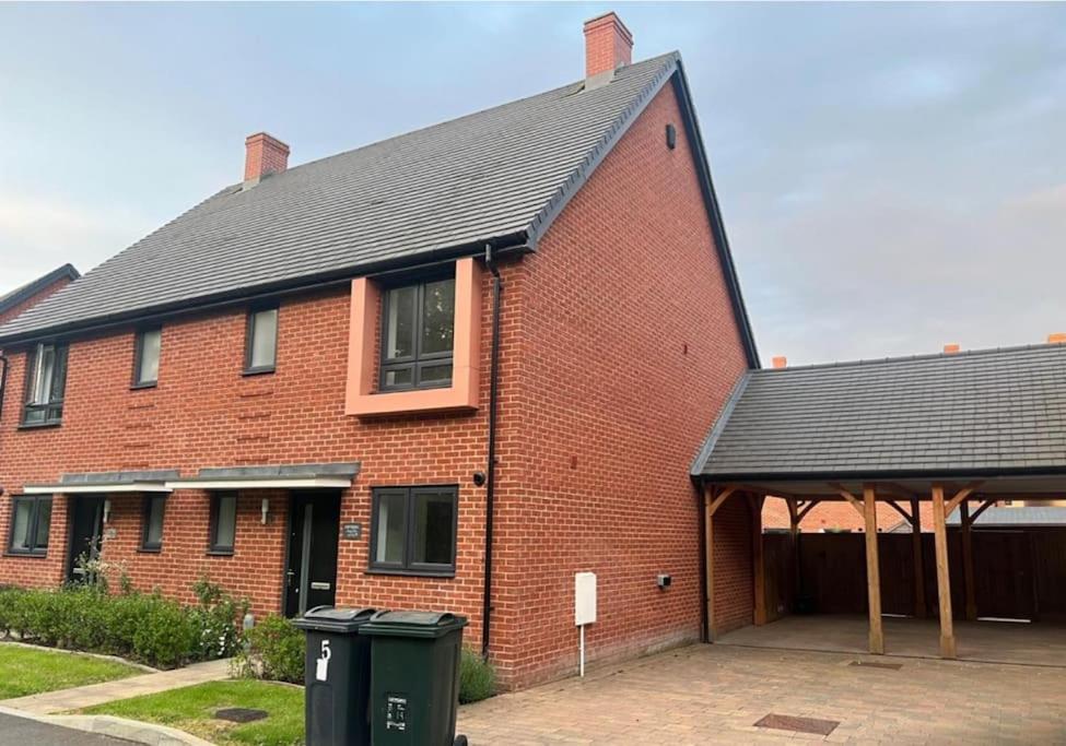 アシュフォードにあるAshford Retreat - Luxury Home with Double Parkingの黒い屋根の赤いレンガの家