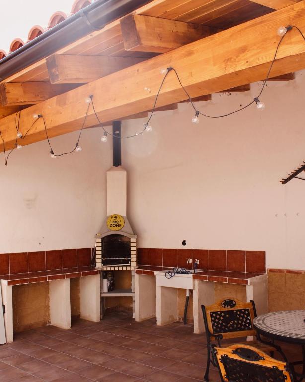 a room with a fireplace and a table and chairs at La Carbonera in Alaejos