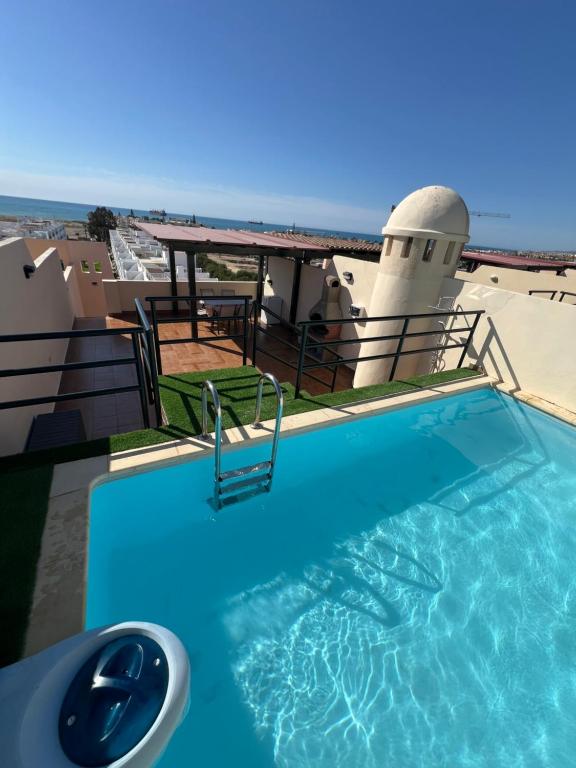 a swimming pool on the roof of a building at Ático con vistas al mar y piscina privada in Vera