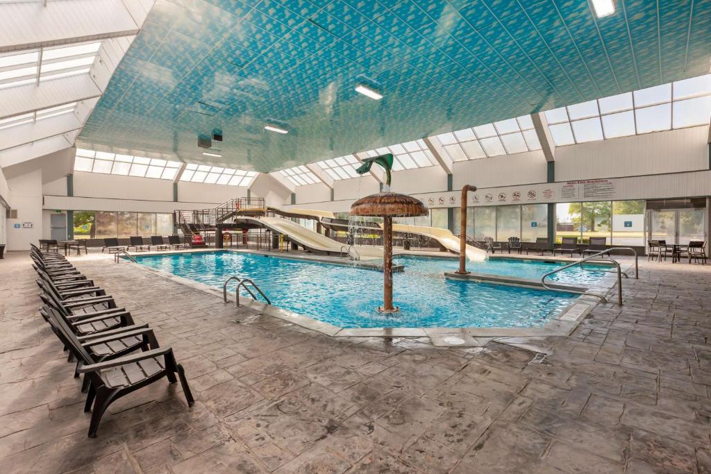 a large swimming pool with a slide in a building at Best Western Plus Leamington Hotel & Conference Centre in Leamington