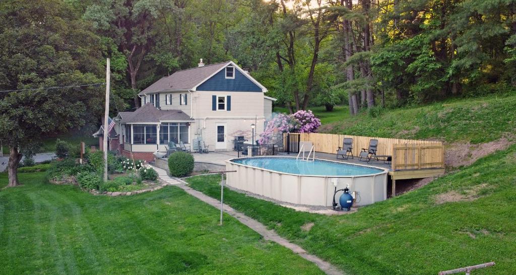 a house with a swimming pool in the yard at Creekside Farmstead Hot Tub with Brand New Pool and BBQ in Auburn
