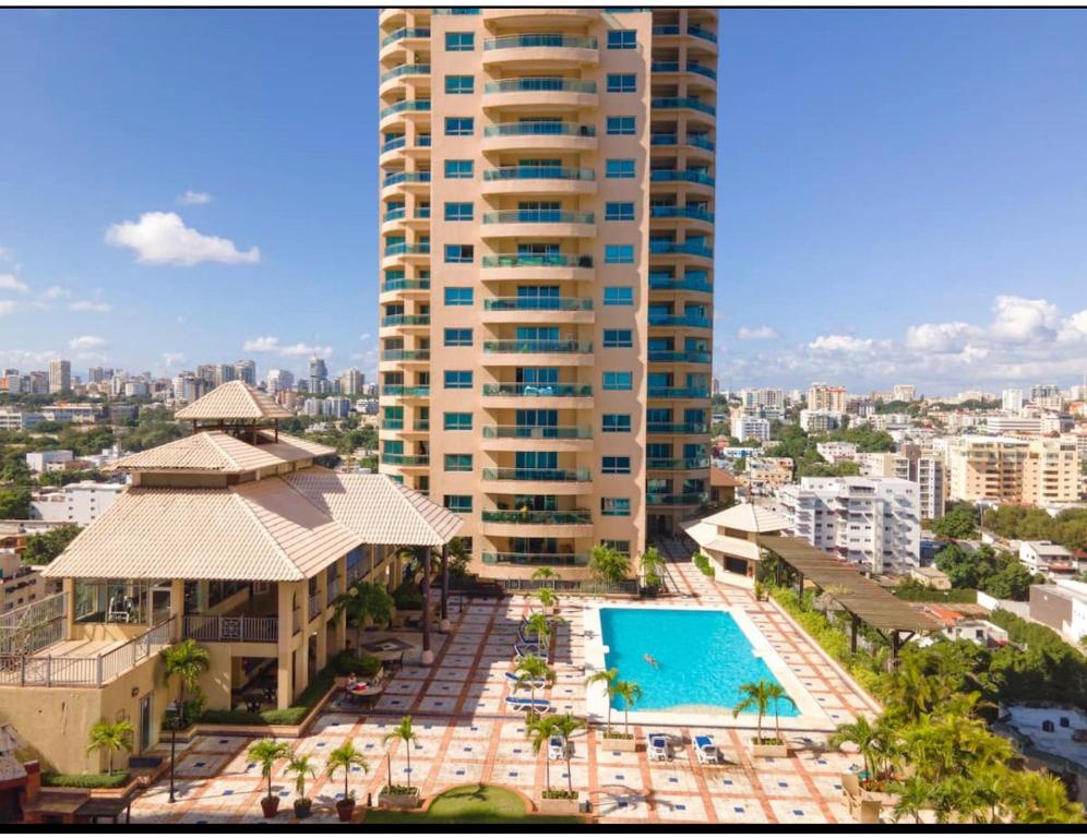 an aerial view of a large building with a swimming pool at Spectacular Condominium between the city and the sea in Santo Domingo