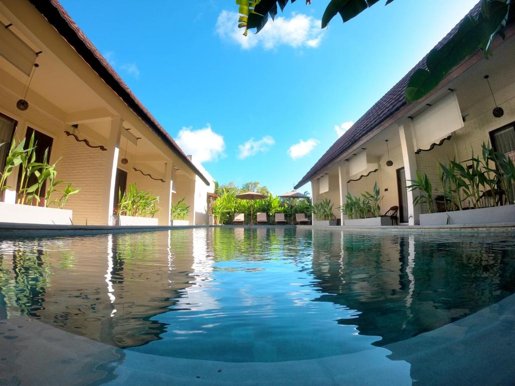 a swimming pool in the middle of a building at Bruga Villas Restaurant and Spa in Selong Belanak