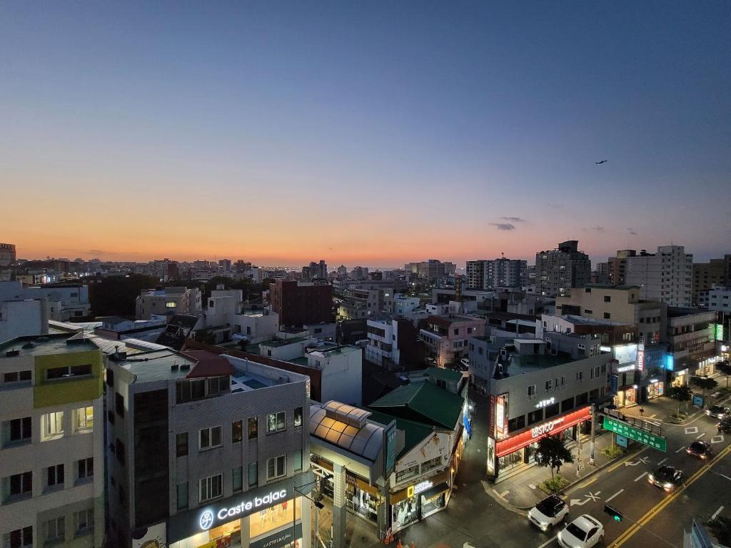 a view of a city at night at Idling Lab Guesthouse in Jeju