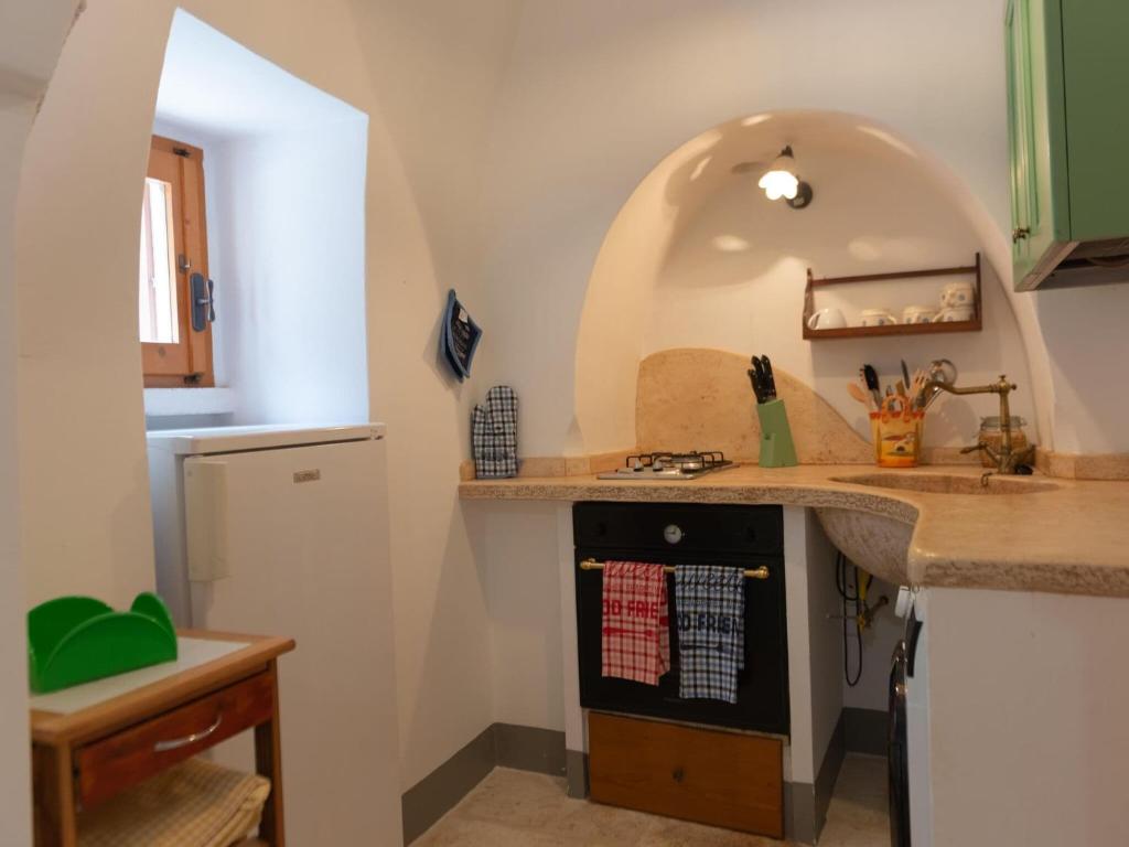 A kitchen or kitchenette at Historic Trulli Azzalema in Cisternino