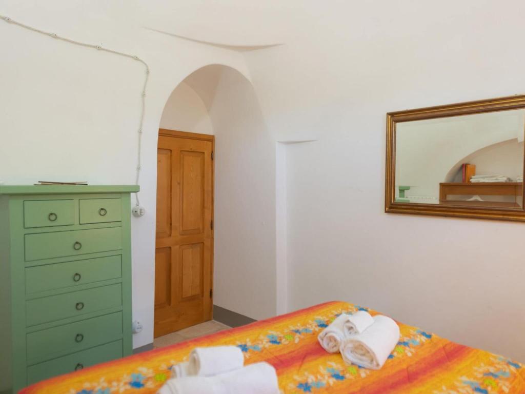 A bed or beds in a room at Historic Trulli Azzalema in Cisternino